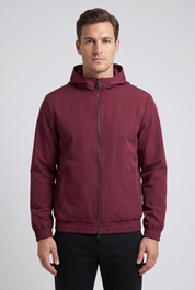 Homme portant la veste a capuche bordeaux MONVALERE, vue de face, cadrage mi-cuisse, fond studio gris clair