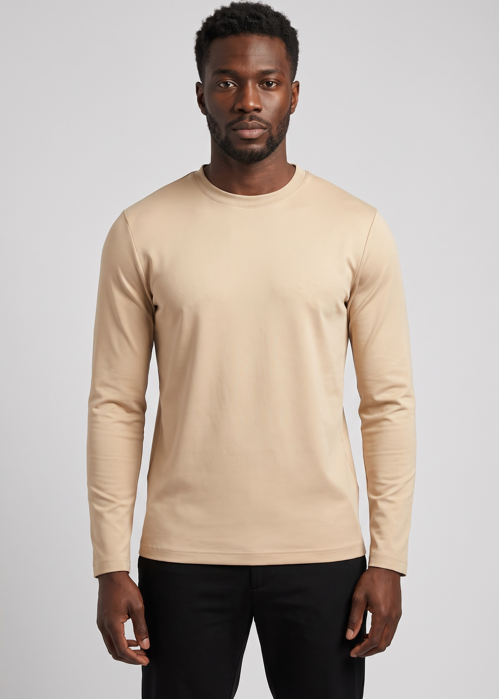 Homme portant le t-shirt manches longues beige MONVALERE, vue de face, cadrage mi-cuisse, fond studio gris clair